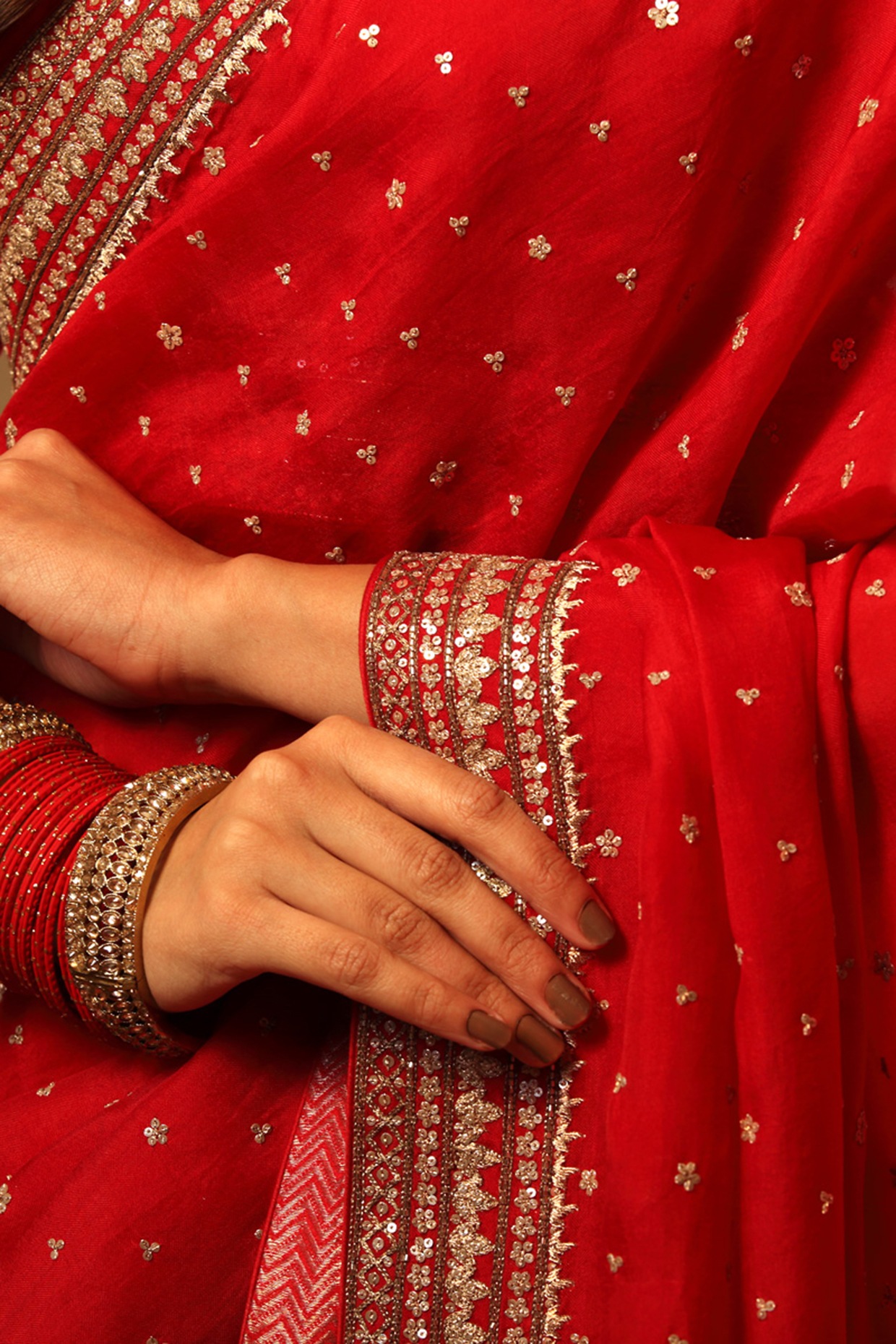 wearing a deep red color silk Saree